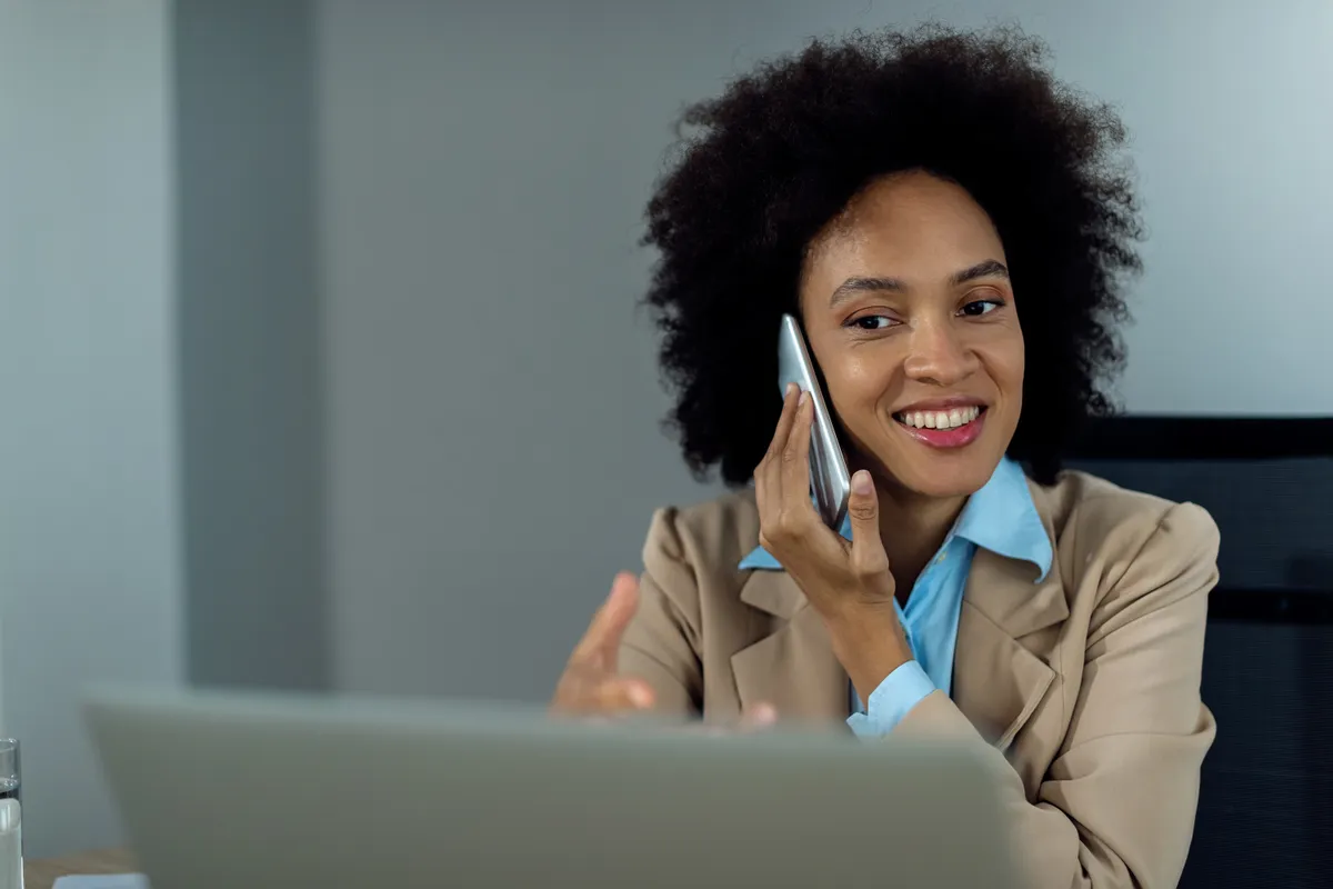 A business owner taking a call at her desk